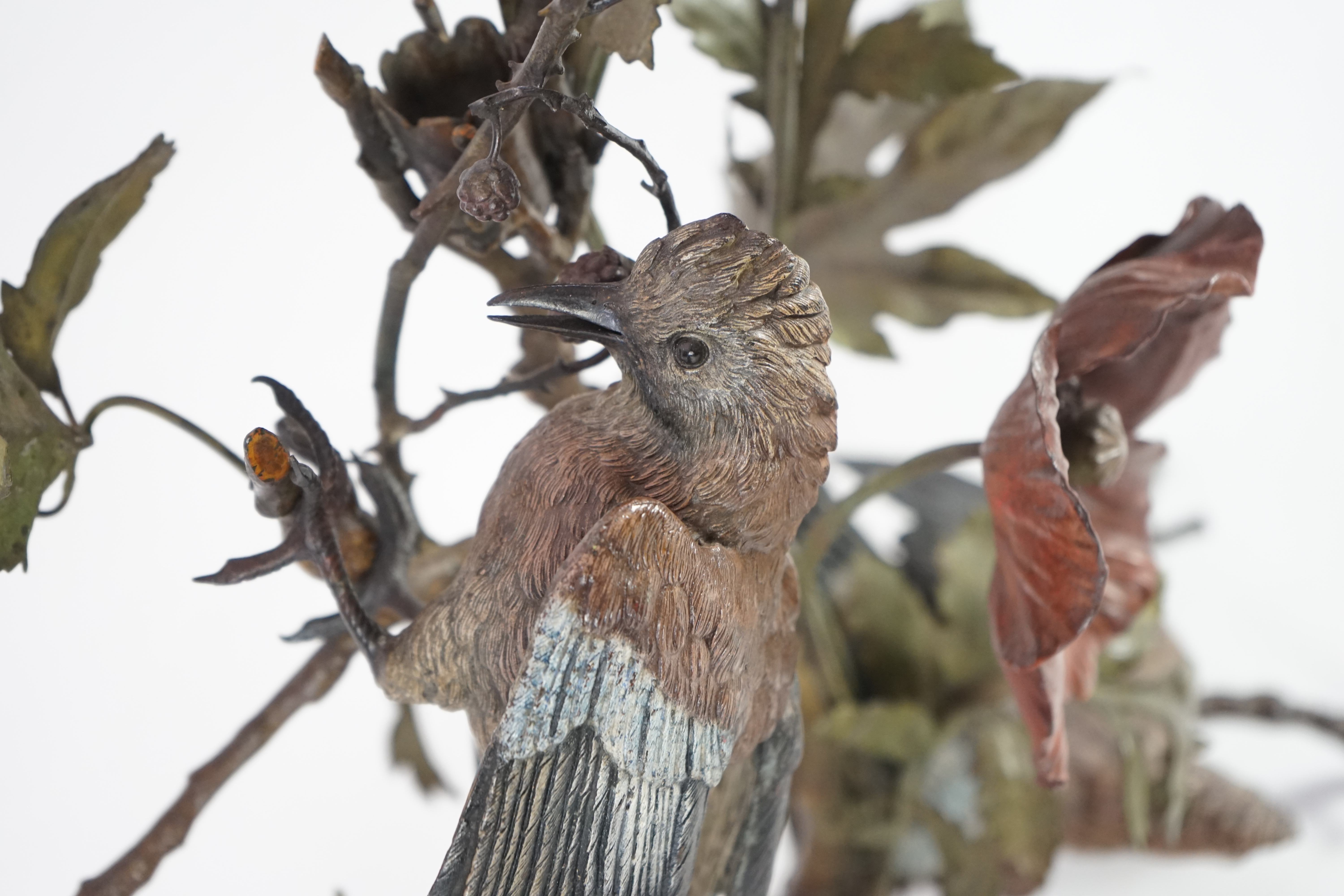 An impressive late 19th century Austrian cold painted bronze group of three jays perched amongst branches